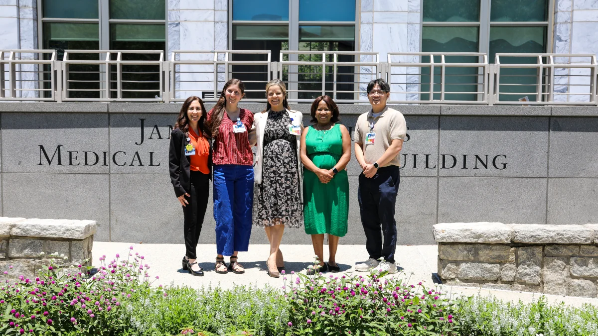 4:03 PMClaude responded: Five EmWELL team members standing together outside the James Medical Building at Emory, with a flower garden in the foreground.Five EmWELL team members standing together outside the James Medical Building at Emory, with a flower garden in the foreground